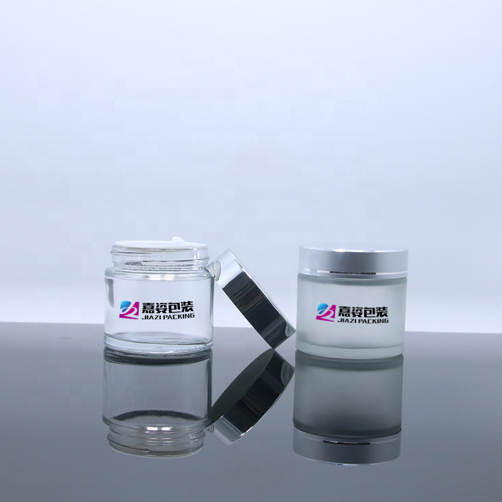 Luxury cosmetic cream glass container clear frosted glass packaging custom 2oz 60g glass jars with sealed silver aluminium lid