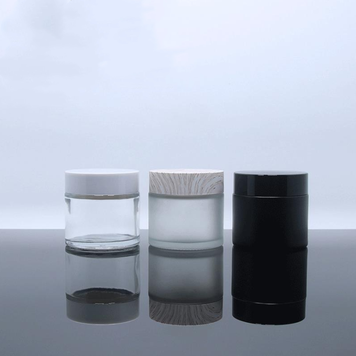 Luxury cosmetic cream glass container clear frosted glass packaging custom 2oz 60g glass jars with sealed silver aluminium lid