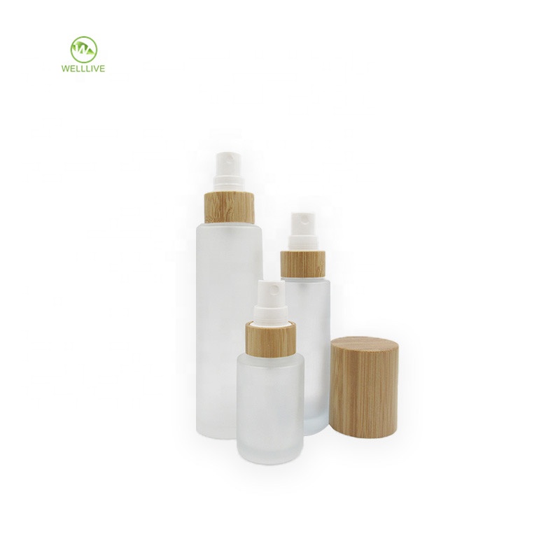 Luxury cylinder cosmetic container clear frosted glass pump bottle 50ml 60ml 2 oz with bamboo wooden sprayer lid