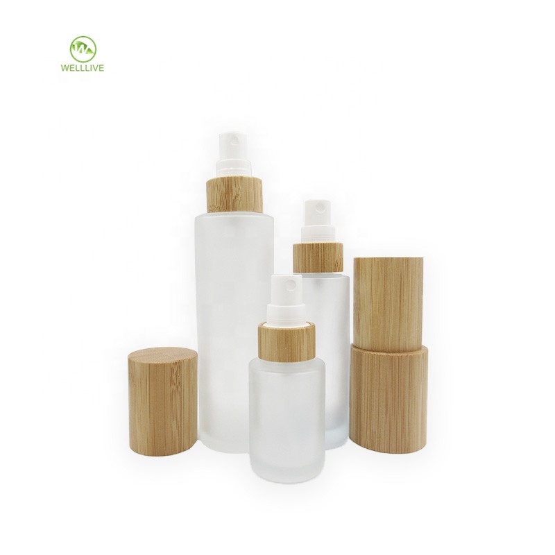 Luxury cylinder cosmetic container clear frosted glass pump bottle 50ml 60ml 2 oz with bamboo wooden sprayer lid