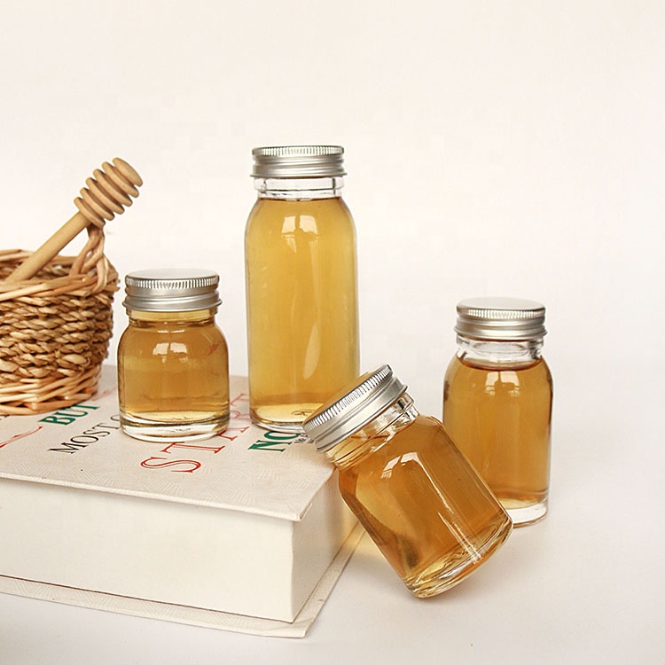 Luxury heavy base flint 50ml 100ml round empty honey sauce packaging bottles with lid wholesale