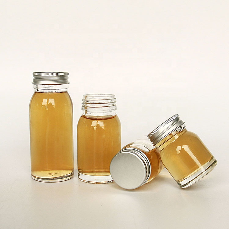 Luxury heavy base flint 50ml 100ml round empty honey sauce packaging bottles with lid wholesale