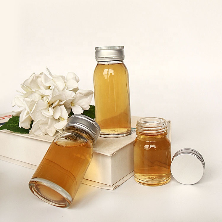 Luxury heavy base flint 50ml 100ml round empty honey sauce packaging bottles with lid wholesale