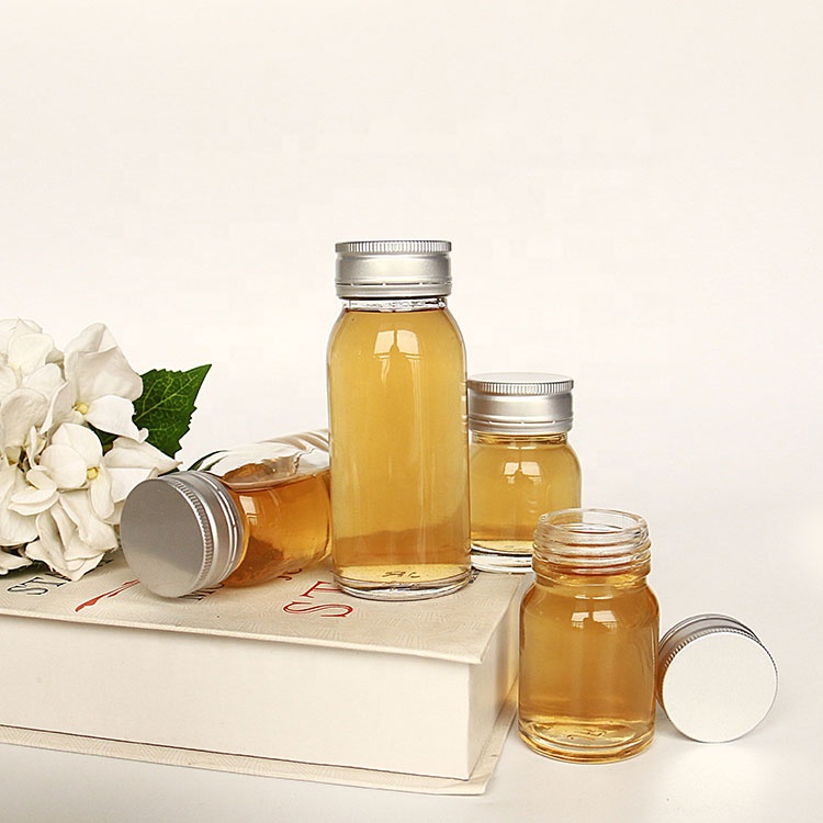 Luxury heavy base flint 50ml 100ml round empty honey sauce packaging bottles with lid wholesale