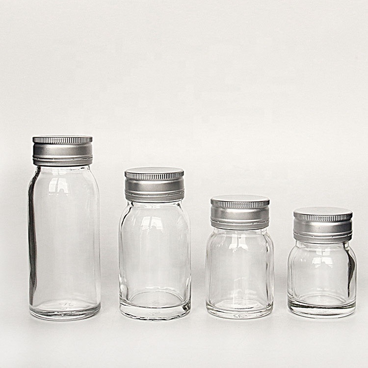 Luxury heavy base flint 50ml 100ml round empty honey sauce packaging bottles with lid wholesale