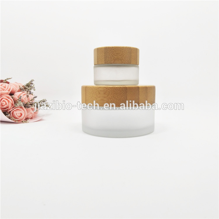Luxury wholesale 5g 10g 15g20g 30g 50g 60g 100g cosmetic jar empty glass jars with relief logo wooden lid