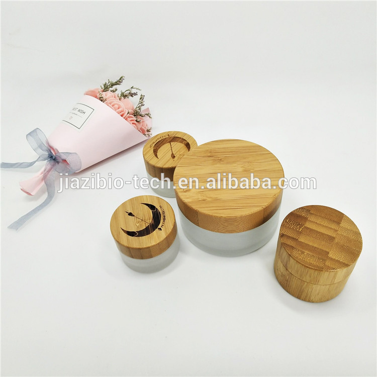 Luxury wholesale 5g 10g 15g20g 30g 50g 60g 100g cosmetic jar empty glass jars with relief logo wooden lid