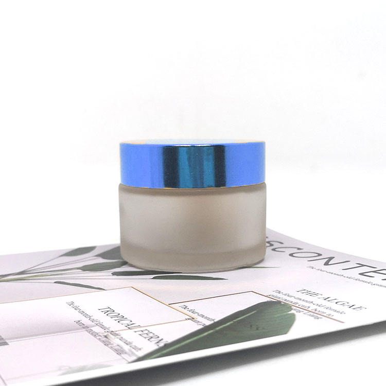 Luxury wholesale 5g 10g 20g 30g 50g 100g 200g amber cosmetic jar empty frosted glass jars with relief logo rose gold lid