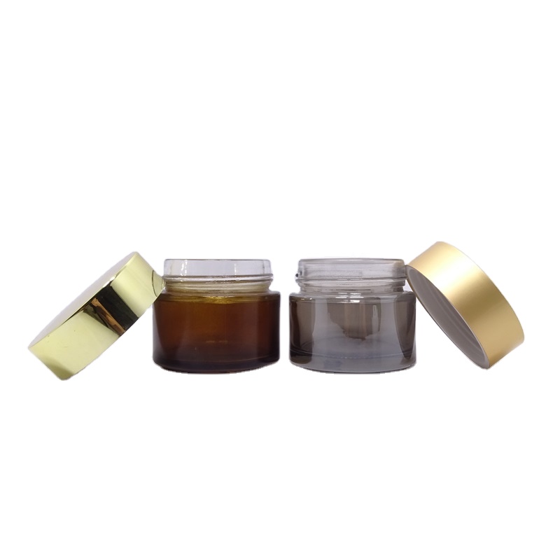 Luxury wholesale 5g 10g 20g 30g 50g 60g 100g 200g transparent black skincare cream empty glass jars with gold lid