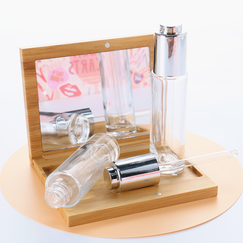Manufacturer Direct Supply Cylinder Shape Silver Lid Pressed Pump Glass Dropper 30ml Empty Glass Serum Bottle