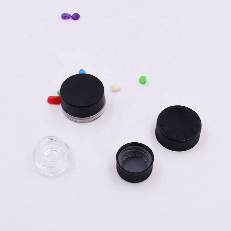 New 9 ml clear round small straight side eye cream cosmetic packing glass jar with black plastic child proof lid.