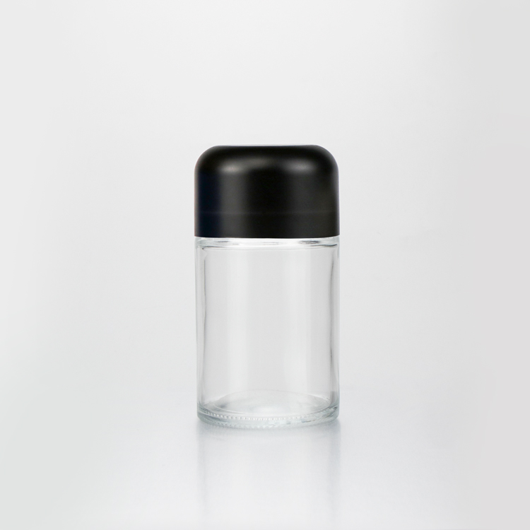 New arrival 50g 70g 110g transparent empty round bottom CR flush cap flower glass jar with wooden child proof cap