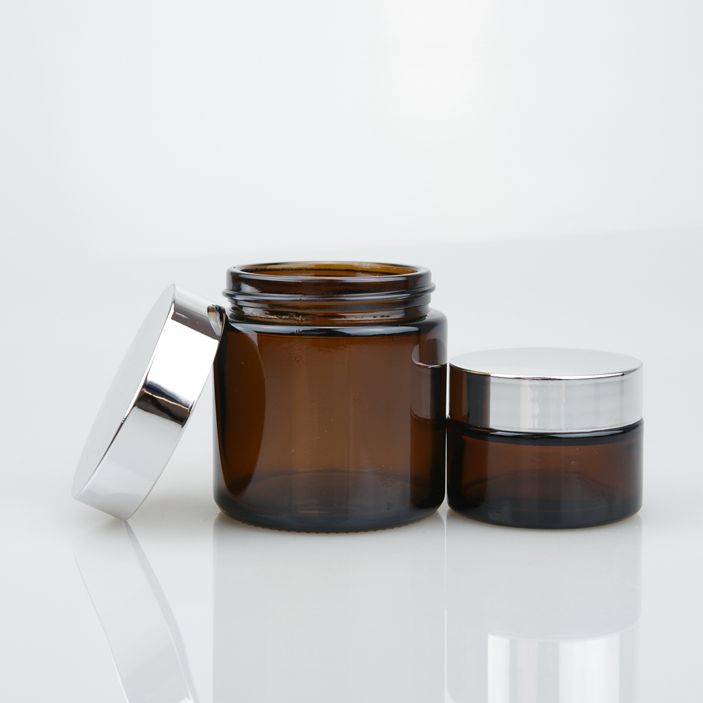 OEM 20ml 30ml 50ml 100ml clear amber cosmetic cream glass jar with gold and silver lid