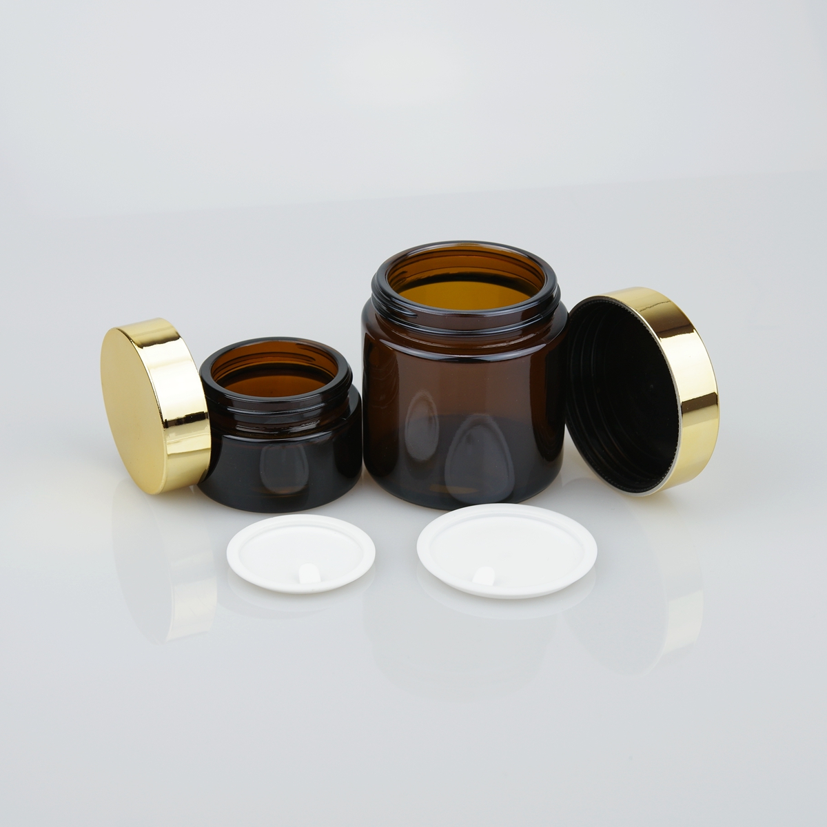 OEM 20ml 30ml 50ml 100ml clear amber cosmetic cream glass jar with gold and silver lid
