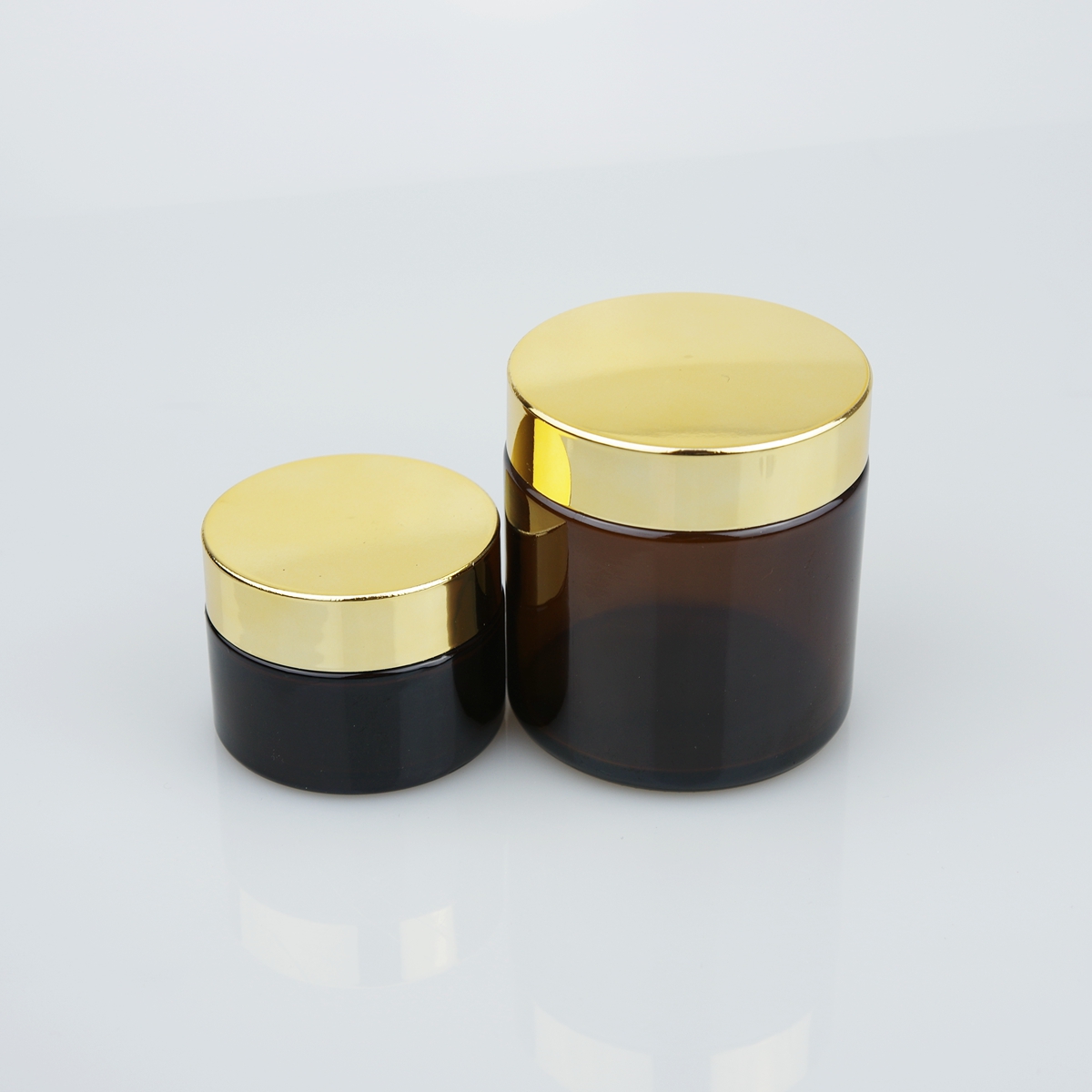 OEM 20ml 30ml 50ml 100ml clear amber cosmetic cream glass jar with gold and silver lid