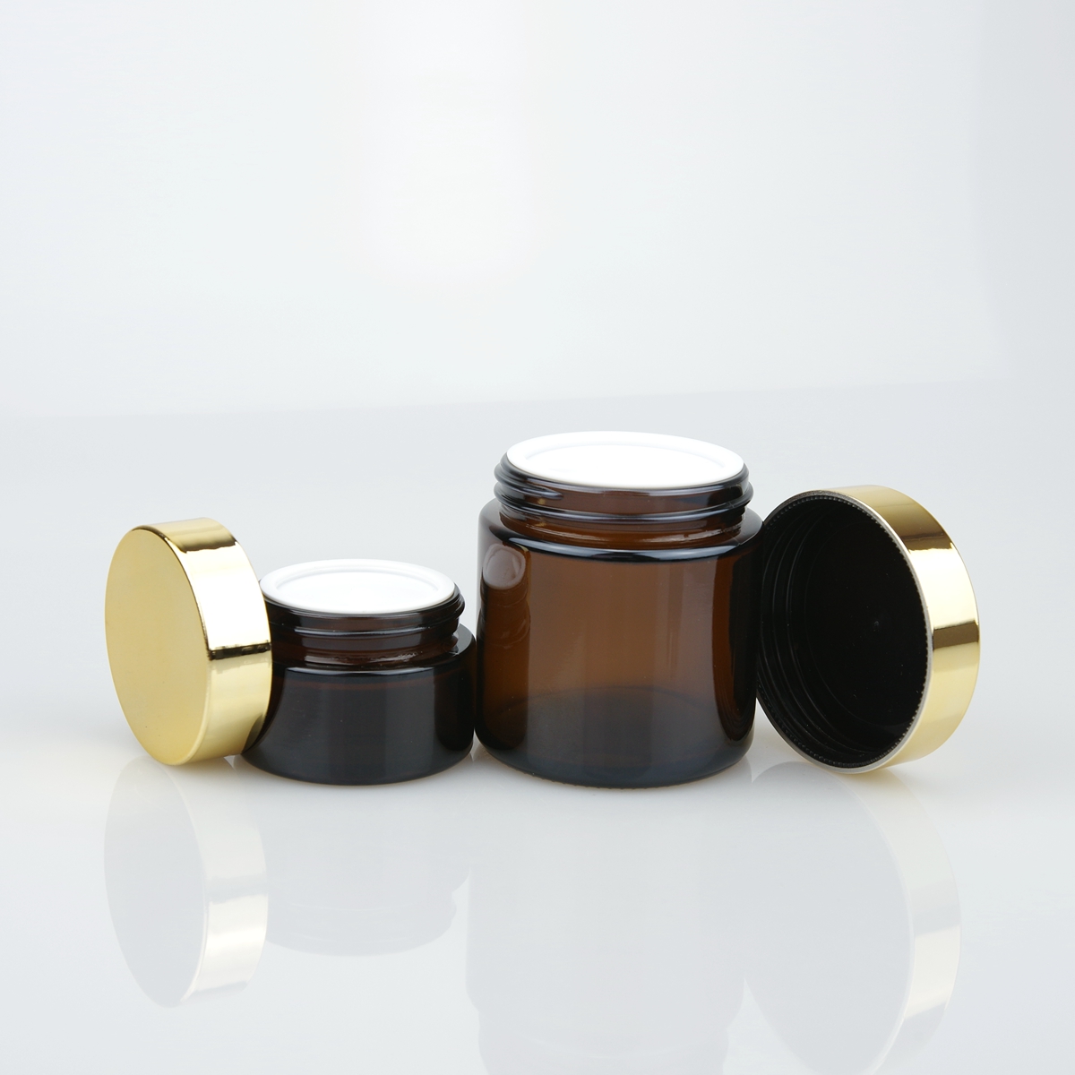 OEM 20ml 30ml 50ml 100ml clear amber cosmetic cream glass jar with gold and silver lid