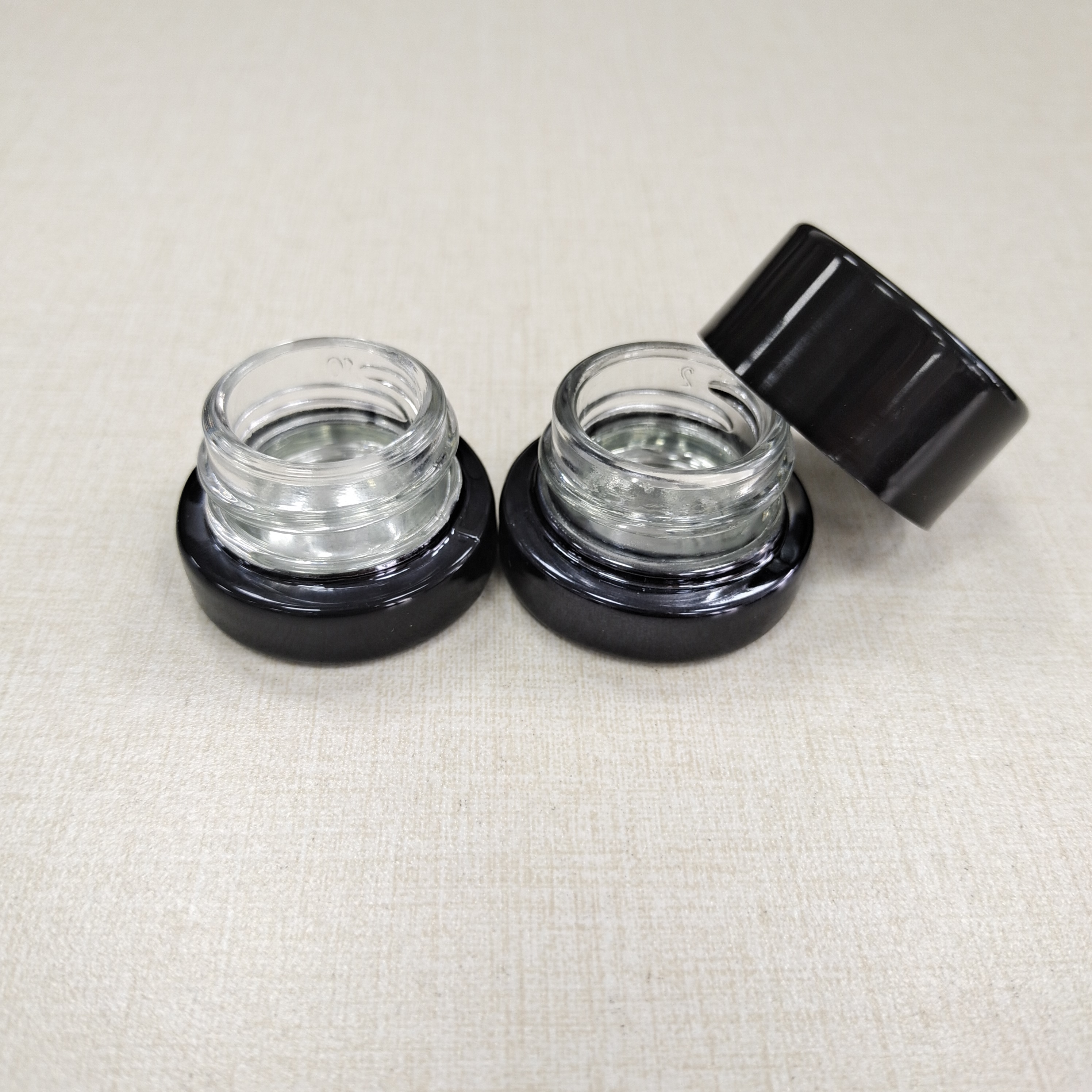 Painted black 5ml glass cosmetics jar with child resistant black cap