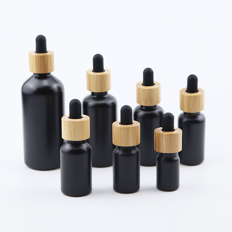 Popular 10ml 15ml 20ml 30ml 50ml 100ml euro round matte black glass dropper bottle with bamboo cap