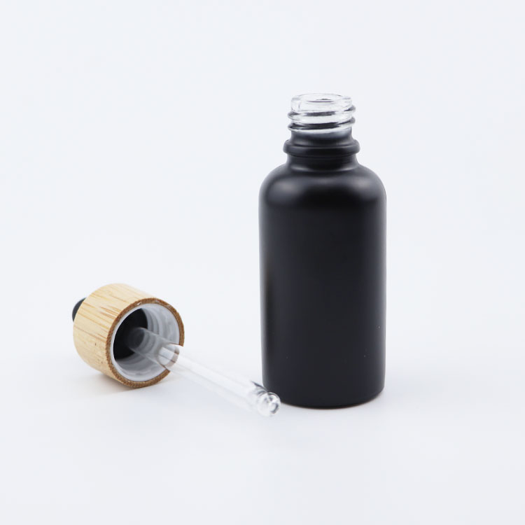 Popular 10ml 15ml 20ml 30ml 50ml 100ml euro round matte black glass dropper bottle with bamboo cap