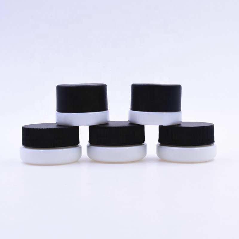 Popular 9 ml white round small straight side eye cream cosmetic packing glass jar with black plastic child proof lid.