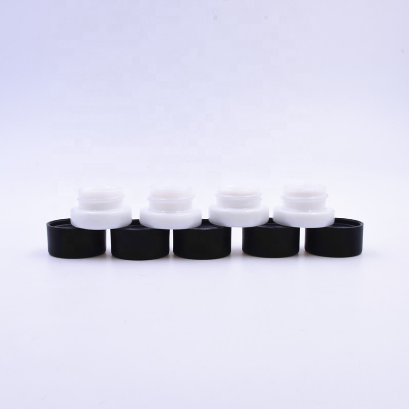 Popular 9 ml white round small straight side eye cream cosmetic packing glass jar with black plastic child proof lid.
