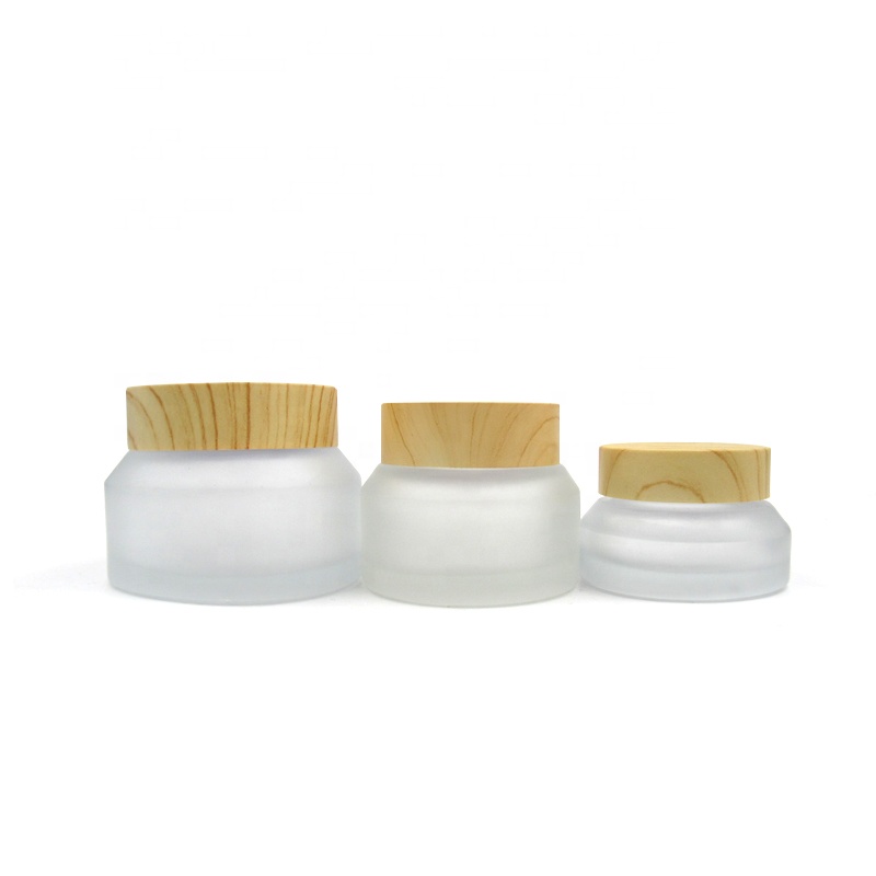 Portable travel size cosmetic jars 15g 30g 50g oblique shoulder transparent frosted matte glass cream jars with wood grain lid