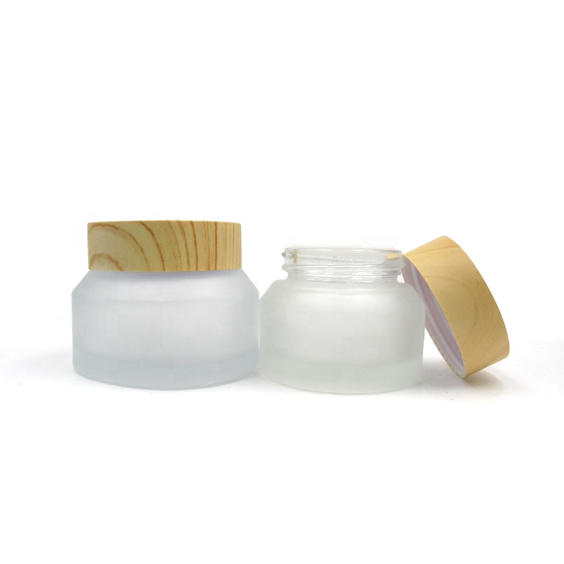 Portable travel size cosmetic jars 15g 30g 50g oblique shoulder transparent frosted matte glass cream jars with wood grain lid