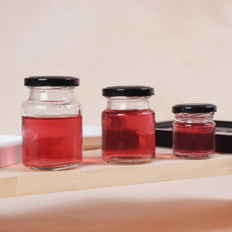 Round 50ml 75ml 100ml glass jars storage supplies in bulk mini glass jar for bird nest drink sauce food jam with black metal lid