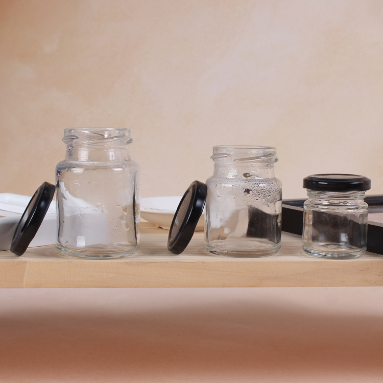 Round 50ml 75ml 100ml glass jars storage supplies in bulk mini glass jar for bird nest drink sauce food jam with black metal lid