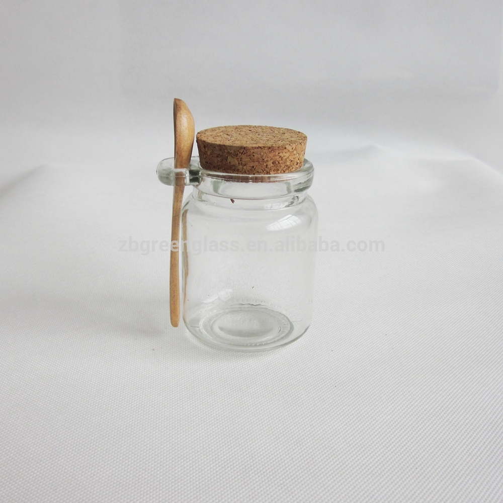 Round honey jar with cork lid and wooden spoon