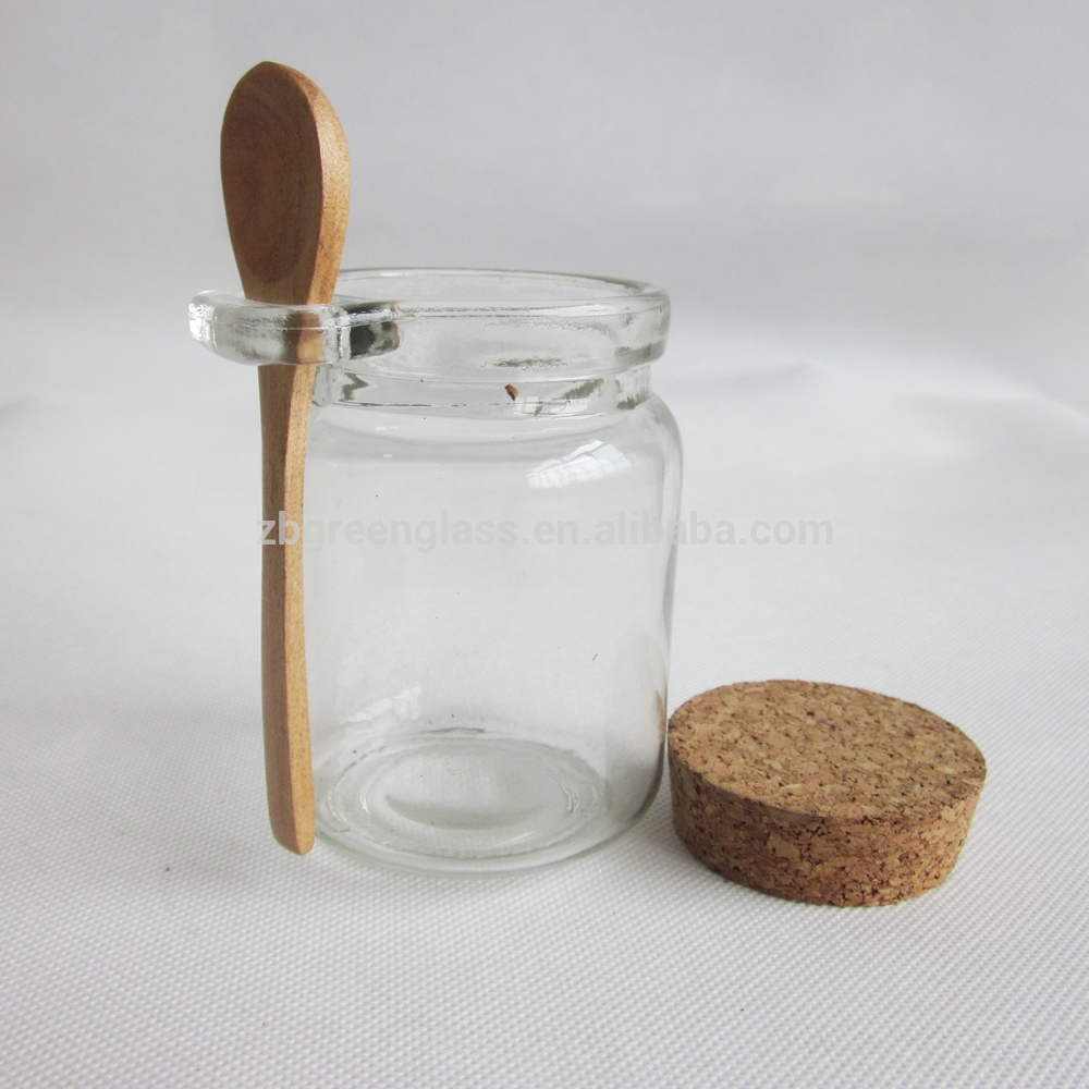 Round honey jar with cork lid and wooden spoon