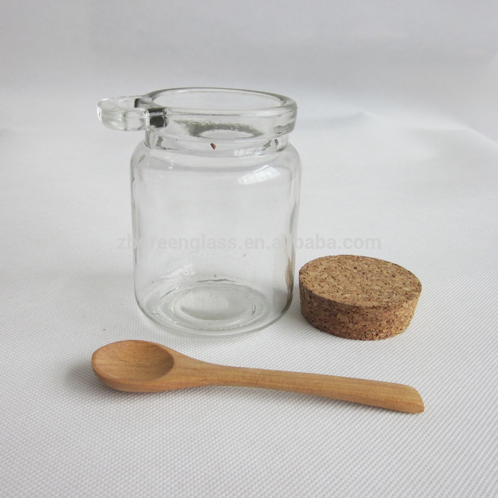 Round honey jar with cork lid and wooden spoon