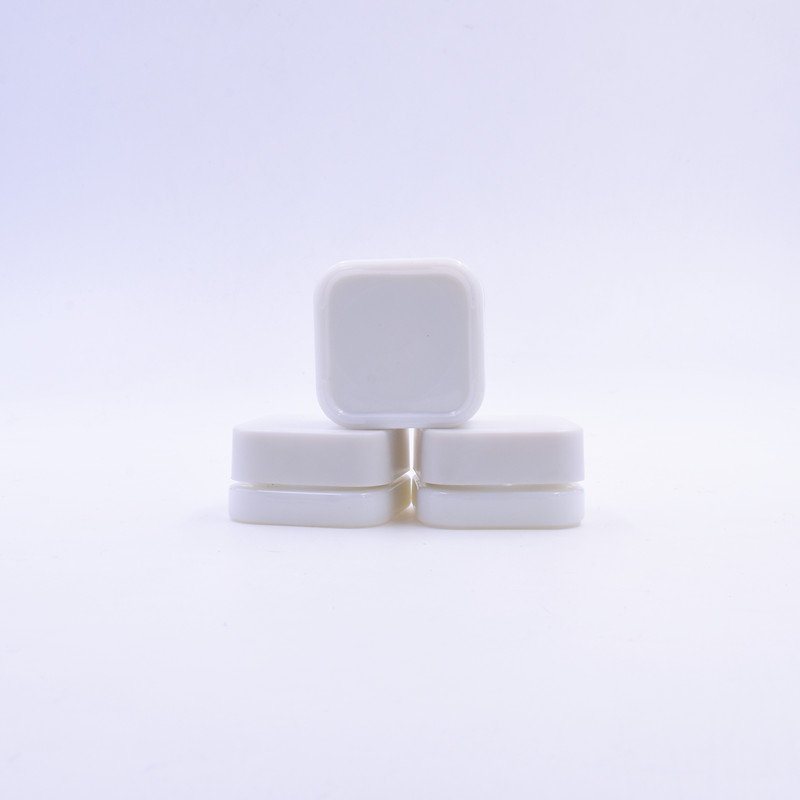 Small 3 ml white round small straight side eye cream cosmetic packing glass jar with black plastic child proof lid.