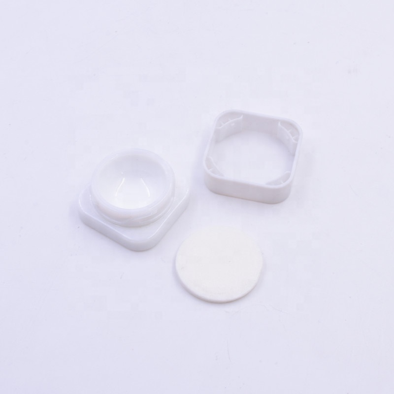 Small 3 ml white round small straight side eye cream cosmetic packing glass jar with black plastic child proof lid.