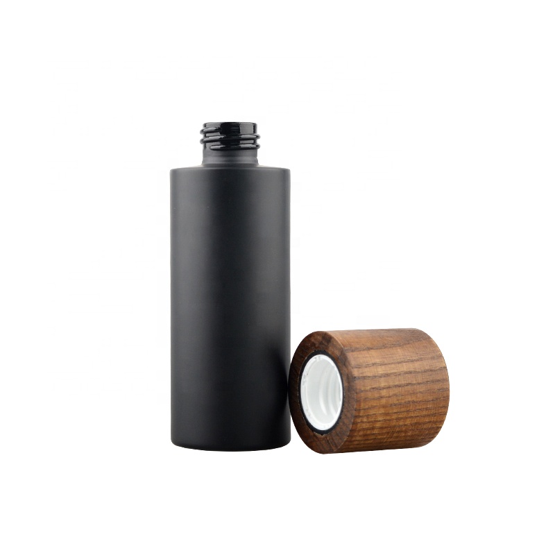 The latest luxury glass cosmetic packaging black glass wooden cap bottle and jar