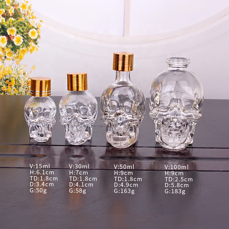 Unique 15ml 30ml 50ml 100ml skull shape essential oil glass bottles with screw lid