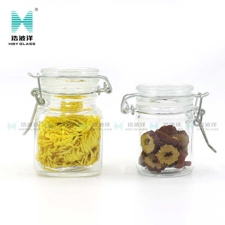 Unique 50ml 75ml 100ml tea food storage glass jar with stainless steel buckle