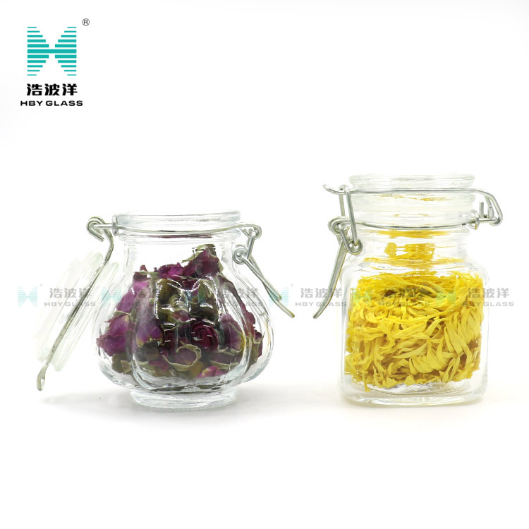 Unique 50ml 75ml 100ml tea food storage glass jar with stainless steel buckle