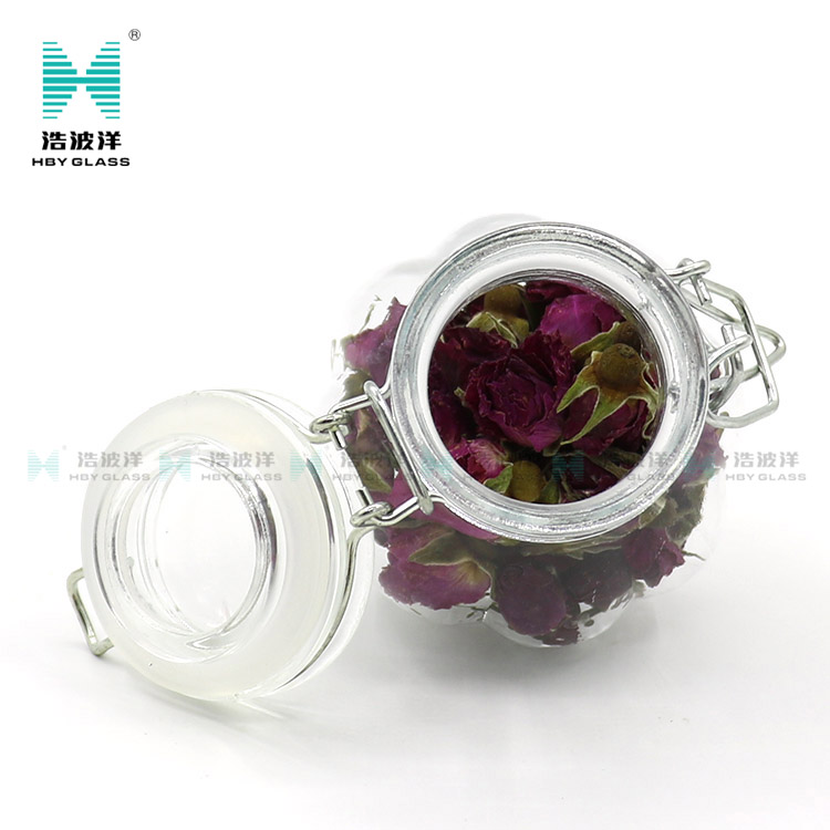 Unique 50ml 75ml 100ml tea food storage glass jar with stainless steel buckle