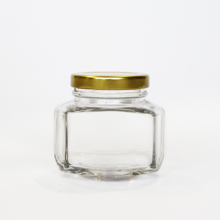 Unique design hexagonal honey packaging jars 150g honey glass bottle with golded lid 110ml