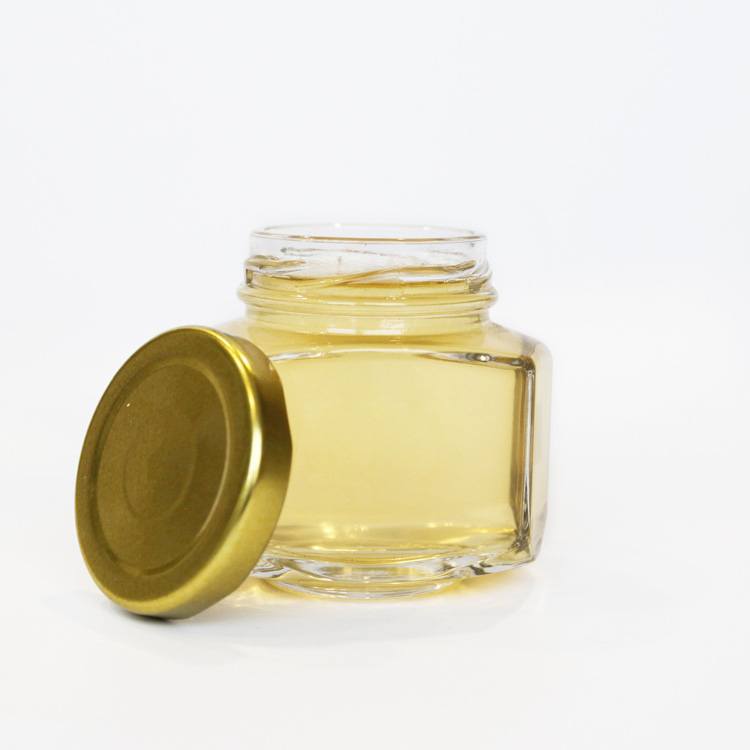 Unique design hexagonal honey packaging jars 150g honey glass bottle with golded lid 110ml