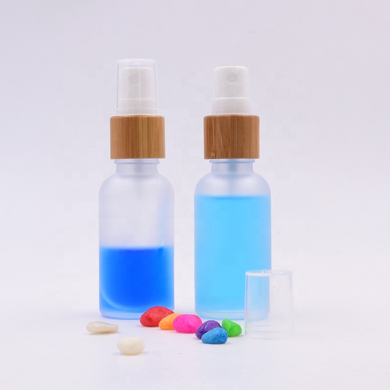 Wholesale 100 ml clear frosted glass bottle essential oil perfume cosmetic packing with plastic white spray