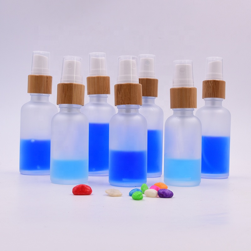 Wholesale 100 ml clear frosted glass bottle essential oil perfume cosmetic packing with plastic white spray