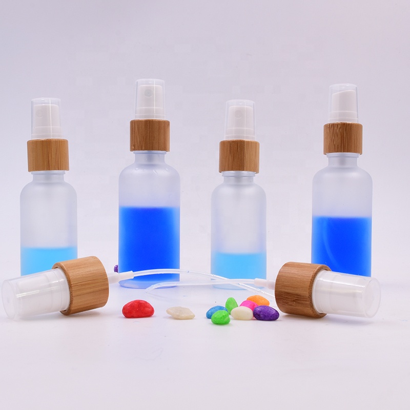 Wholesale 100 ml clear frosted glass bottle essential oil perfume cosmetic packing with plastic white spray