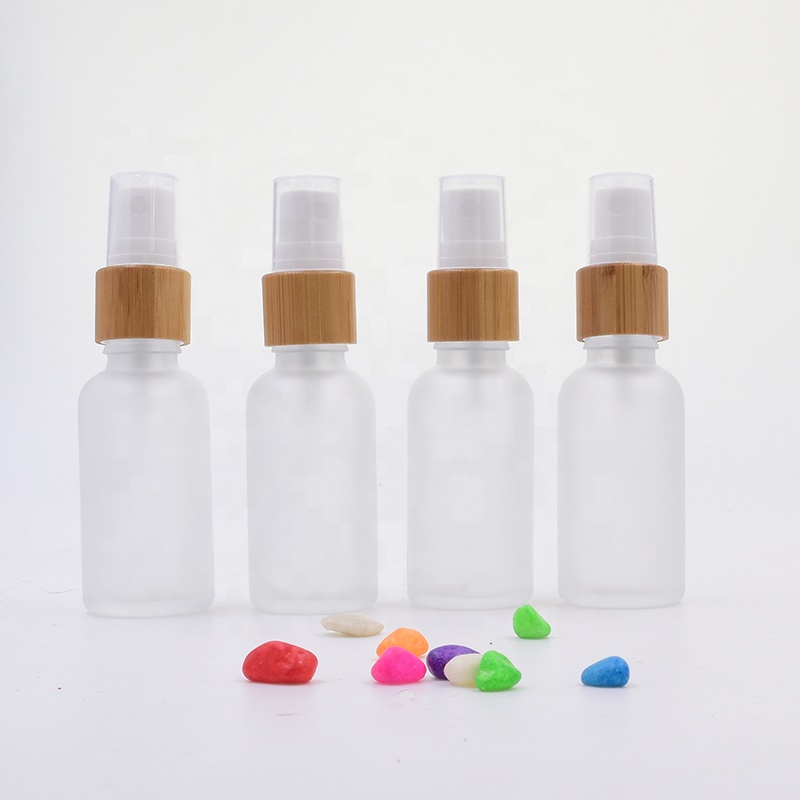 Wholesale 100 ml clear frosted glass bottle essential oil perfume cosmetic packing with plastic white spray
