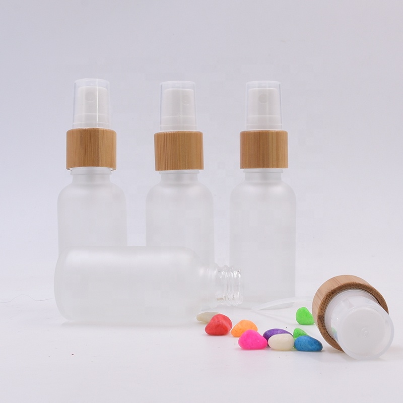 Wholesale 100 ml clear frosted glass bottle essential oil perfume cosmetic packing with plastic white spray