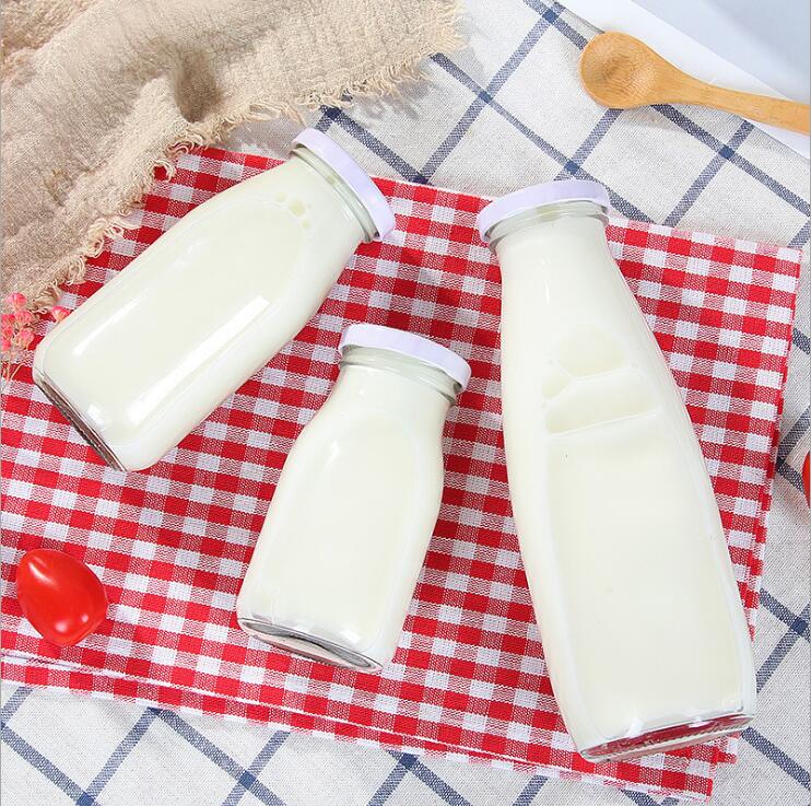 Wholesale 200 ML 250 ML 500 ML 1000 ML clear round milk beverage juice glass bottle with metal lid