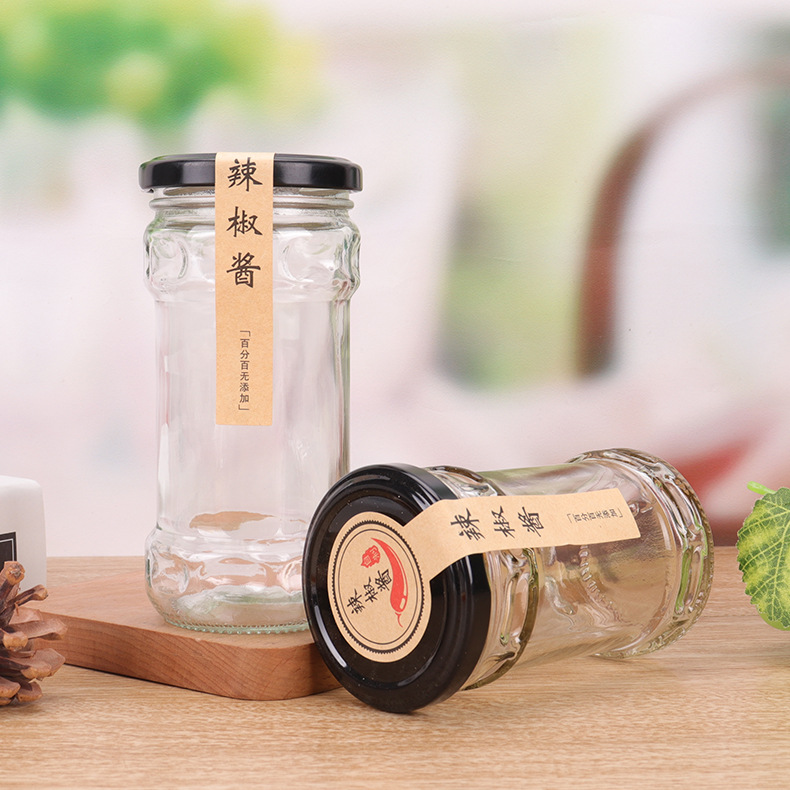 Wholesale 200ml glass jar for pickles food industry empty clear storage jars glass for beef paste ketchup with black metal lids