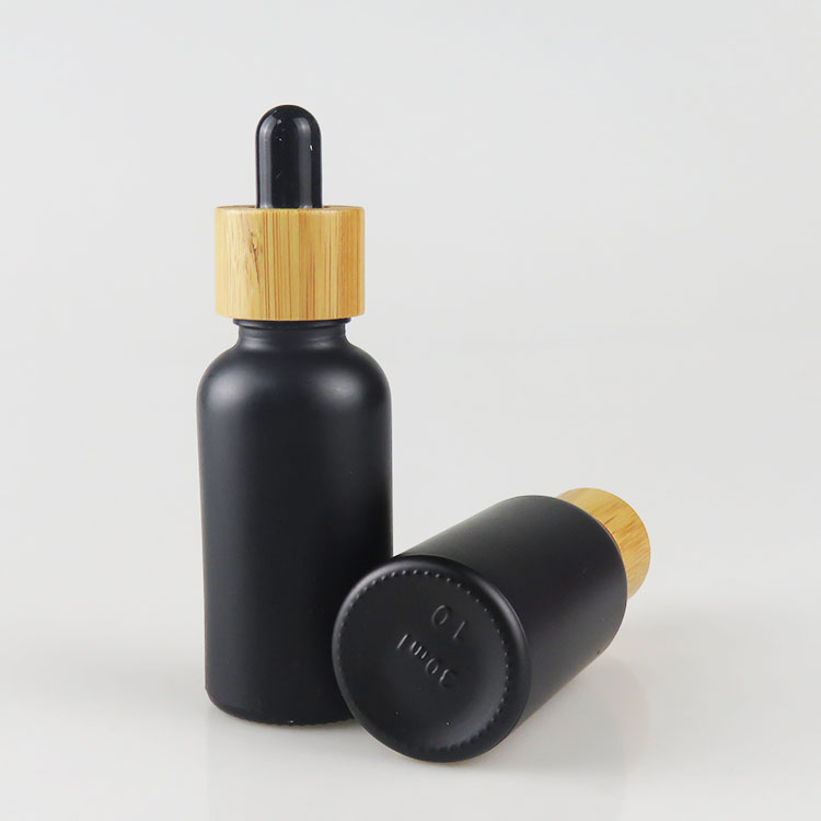 Wholesale 30ml matte frosted black essential oil glass bottle with bamboo dropper cap