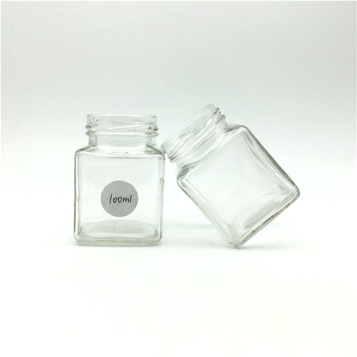 Wholesale 50ml 100ml square empty glass lucid bottle jar for candy sweets Food use